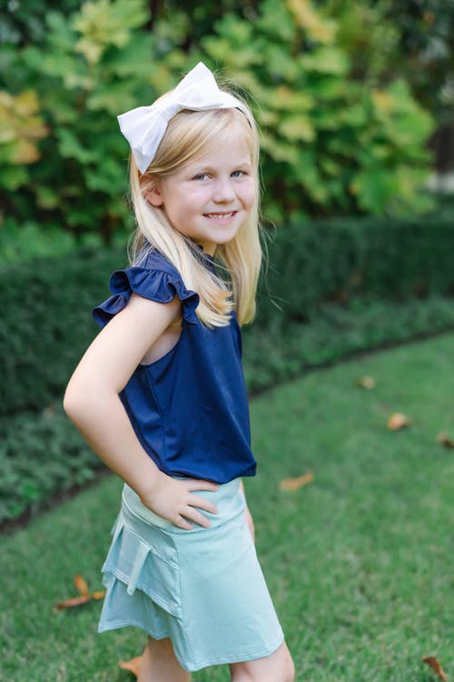 LILA AND HAYES LILA AND HAYES ELLIE GIRLS' SLEEVELESS RUFFLED TOP BY LH SPORT 