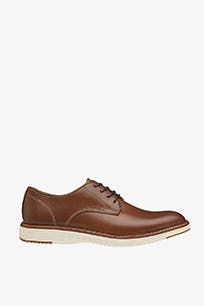 Brown lace-up shoe with white rubber sole.