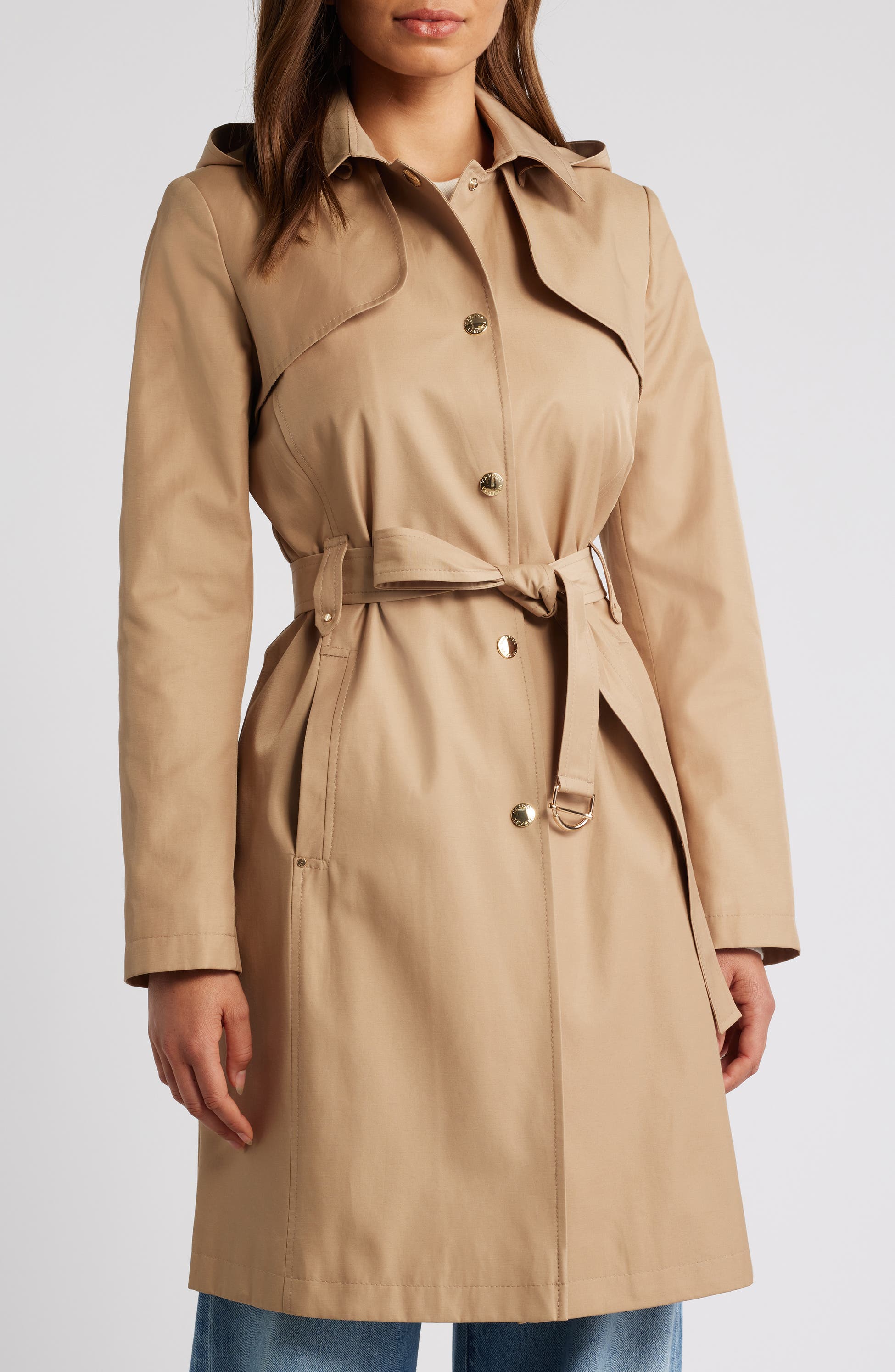 model wearing a camel colored cotton blend trenchcoat