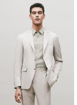 Man in an off-white suit.