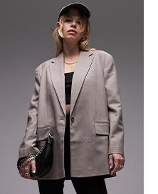 A woman wearing a taupe blazer.